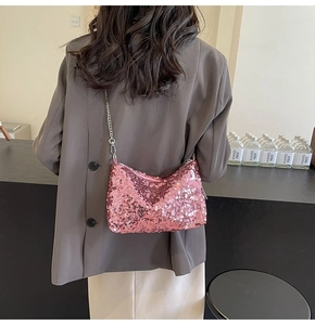 Close-up of pink sequin shoulder bag featuring shiny texture and silver metal chain strap