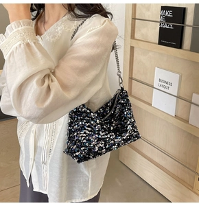 Detail of multi-color sequin shoulder bag featuring silver metal chain and zipper closure