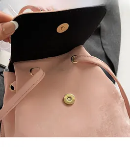 Close-up of magnetic buckle closure and drawstring on pink casual backpack