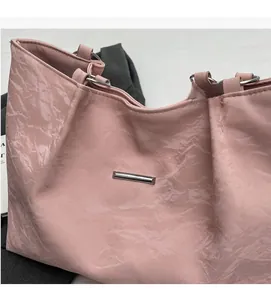 Close-up of pink tote bag showing vintage pleated texture and silver metal decoration