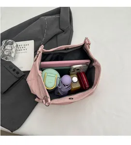 Pink oversized tote bag with large interior space holding a tablet, umbrella, and essentials
