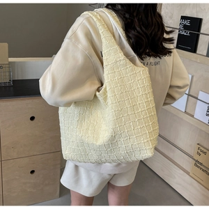 Minimalist pleated yellow tote bag for women shown as a stylish shoulder bag in modern setting
