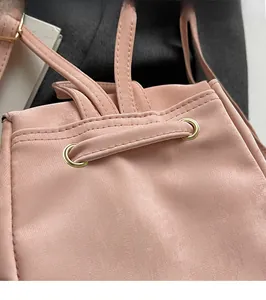 Close-up of pink PU leather backpack with gold metal eyelet and detailed stitching