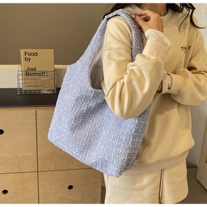 Light blue pleated hobo shoulder bag featuring waffle texture and minimalist design