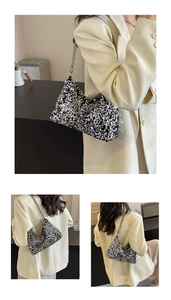 Detail shot of shimmering silver sequin tote bag with metallic chain strap and soft silhouette