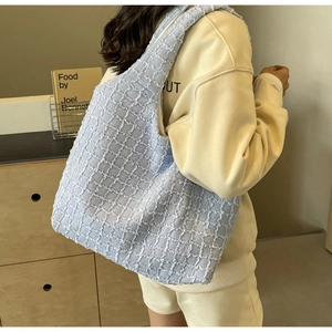 Close-up of light blue bubble textured tote bag showing unique pleated fabric detail