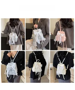 Detail view of ballet style backpack featuring oversized lace bows and ribbon decorations