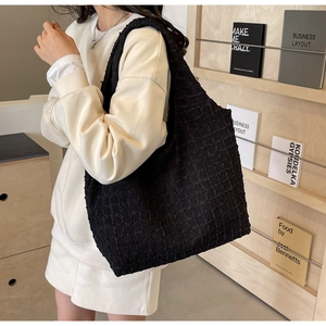 Detailed close-up of textured bubble waffle fabric on black large capacity tote bag