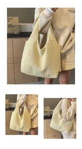 Detail of light yellow quilted tote bag showing textured knit fabric and large capacity