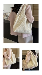 Detail of off-white tweed tote bag showing textured woven fabric and large capacity