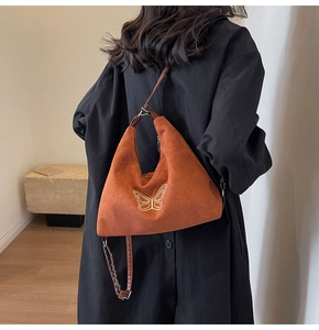 Brown hobo shoulder bag with golden butterfly embroidery and metal chain detail