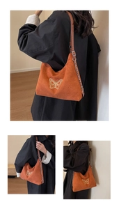 Detail of caramel suede crescent bag with gold butterfly embroidery and chain strap