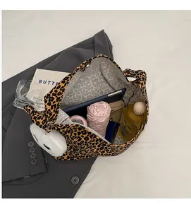 Detail view of leopard print tote bag interior capacity with tablet and daily essentials