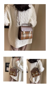 Close-up of retro plaid pattern with gold metal locks and embossed detail on briefcase