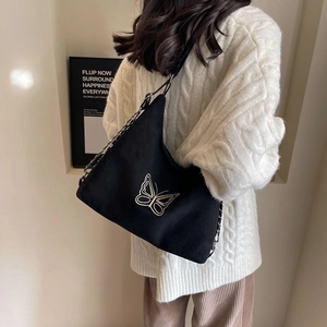 Chic black canvas shoulder bag featuring white butterfly embroidery and chain strap