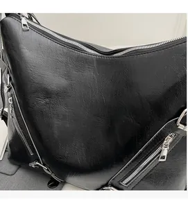 Close-up of soft black PU leather texture and premium metal zipper detail on tote bag