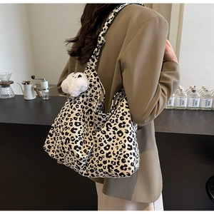 Large leopard print tote bag for women with plush bear charm and integrated shoulder strap