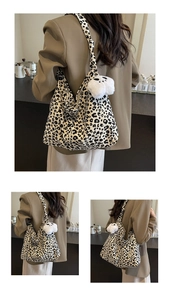 Detail of leopard print hobo bag with panda plush charm and spacious interior texture