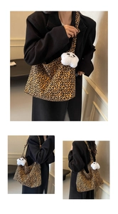 Detail of leopard print tote bag with a white plush panda keychain and spacious interior