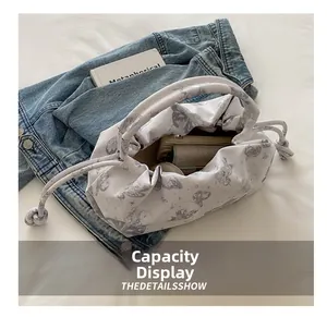 Macro view of butterfly print bag showing spacious interior with phone storage space