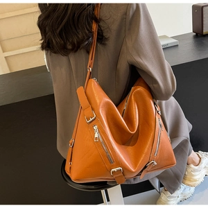 Detailed back view of a large brown PU leather tote bag with stylish zipper accents
