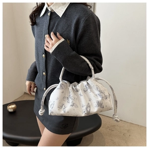 French style white pleated cloud bag with grey butterfly prints on model's shoulder