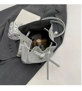 Spacious interior of silver leather bucket bag holding smartphone, wallet and cosmetics