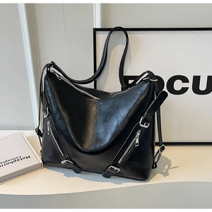 Detailed shot of large black tote bag with silver zippers and buckle details