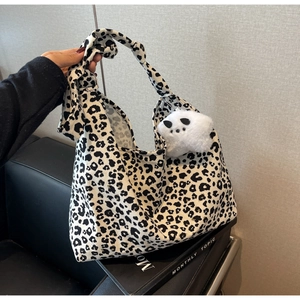 Large leopard print tote bag with plush cat charm and knotted strap for daily use