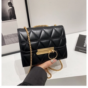 Elegant black quilted crossbody bag with gold chain strap and metallic ring buckle