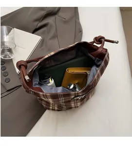 Detail view of large capacity vintage plaid bucket bag showing spacious interior with lining