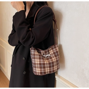 Detail of vintage brown plaid hobo bag featuring a dachshund embroidery patch on the side