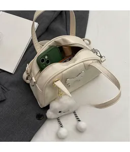 Detail of cream bowling bag interior capacity with butterfly ornament and cloud charm