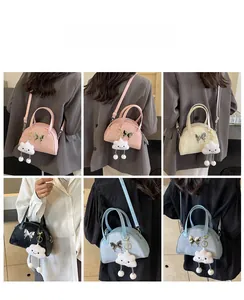 Detailed views of macaron bow bowling bag with cute cloud charm and metal buckle accents