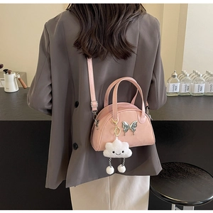 Detailed back view of a pink crossbody bag with cloud pendant and butterfly ornament