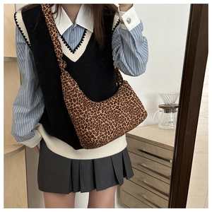 Chic leopard print canvas crossbody bag shown in a stylish mirror selfie setting