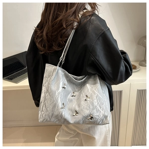 Silver metallic tote bag with crinkled texture and 3D butterfly charms for commute