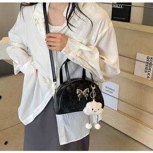 Black leather saddle bag with silver butterfly and white plush cloud pendant