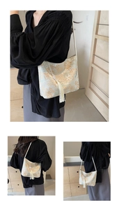 Detail of silk satin bucket bag with gold floral embroidery and long tassel charm
