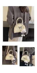 Detail of beige saddle bag featuring silver butterfly buckle and cloud charm accessory
