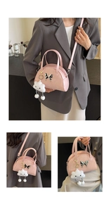 Detailed view of pink saddle bag with silver butterfly charm and cloud pendant