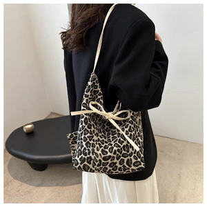 Detail of leopard print bucket bag with drawstring strap and ribbon bow decoration