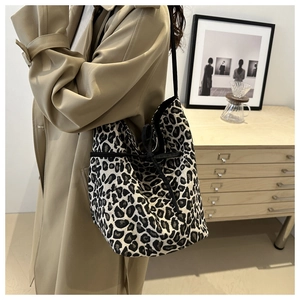 Large leopard print canvas tote bag with drawstring closure and slim shoulder strap