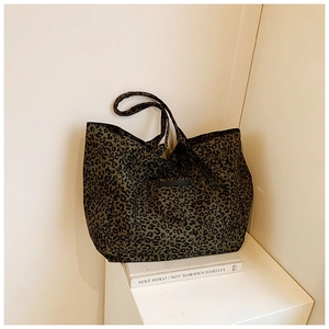 Detail of leopard print canvas tote bag featuring large capacity and durable fabric texture