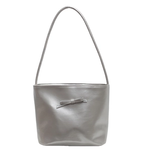 Chic silver metallic tote bag featuring a minimalist bow decoration and long shoulder straps