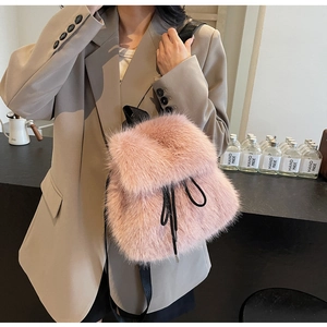 Close-up of pink faux fur backpack featuring a drawstring closure and black straps