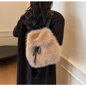 Close-up of light brown faux fur texture and black adjustable straps on the backpack