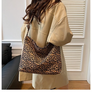 Detail of trendy leopard print tote bag showing wide shoulder strap and fabric texture