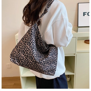 Close-up of leopard print canvas hobo bag showing large capacity and stylish texture