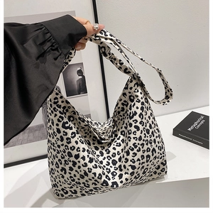 Detail of large leopard print canvas tote bag with black and white animal pattern texture